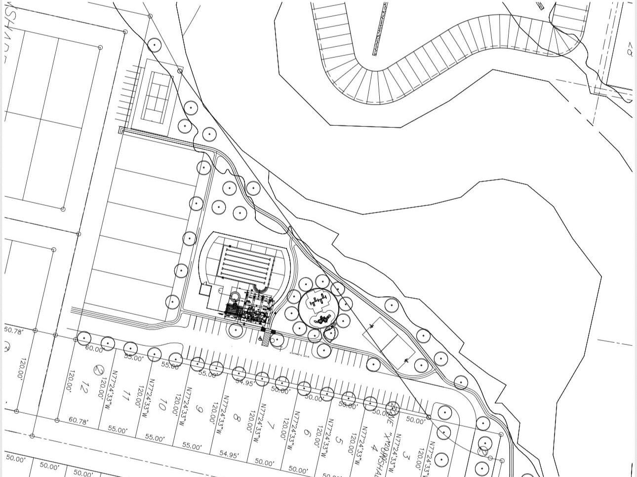 A site plan drawing of a park and amenity area at the centre of a subdivision, with lots along one edge and a drainage channel curving past
